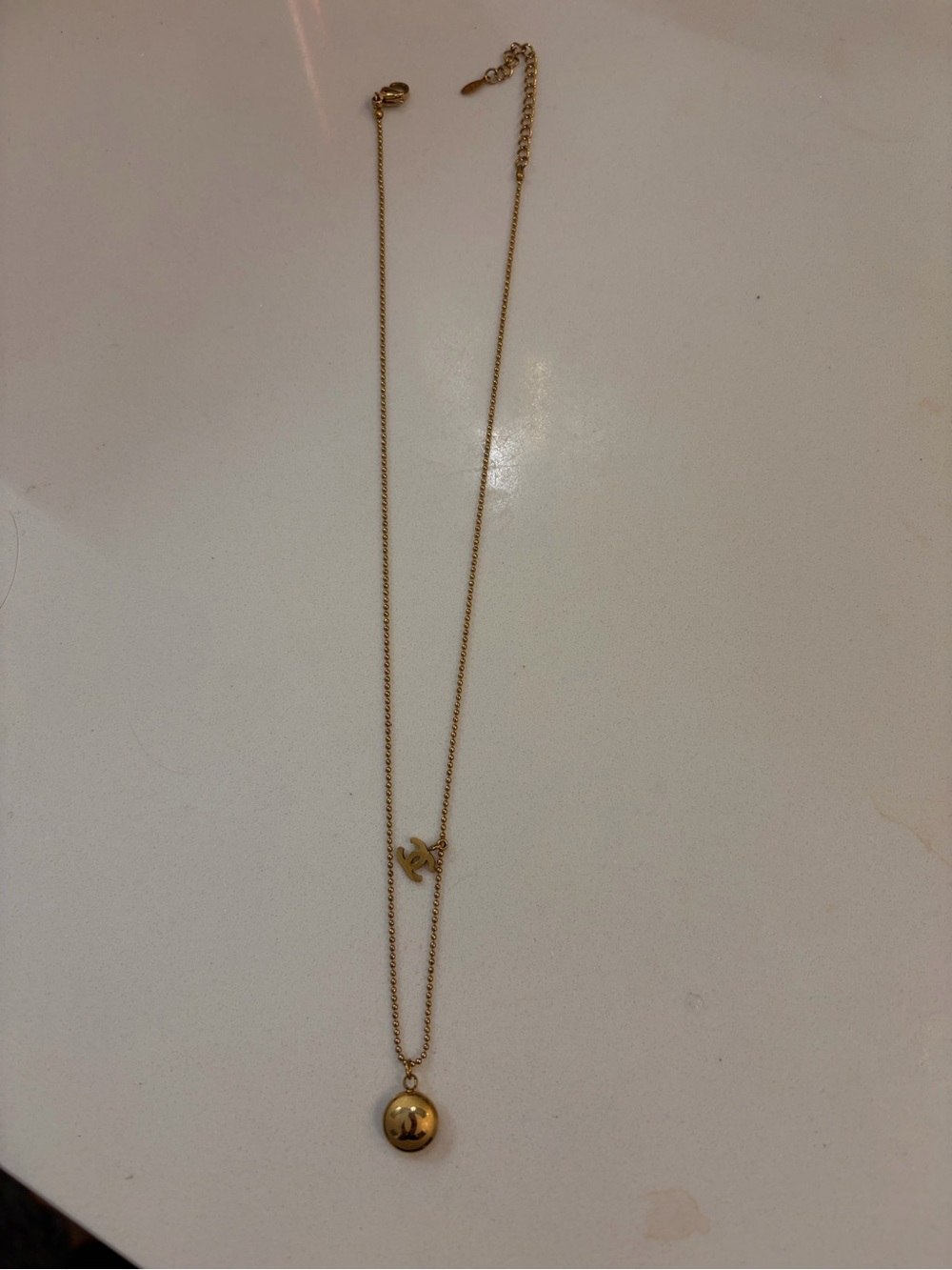 CHANEL Gold Tone Layered Necklace with Round Pendant and Logo Charm